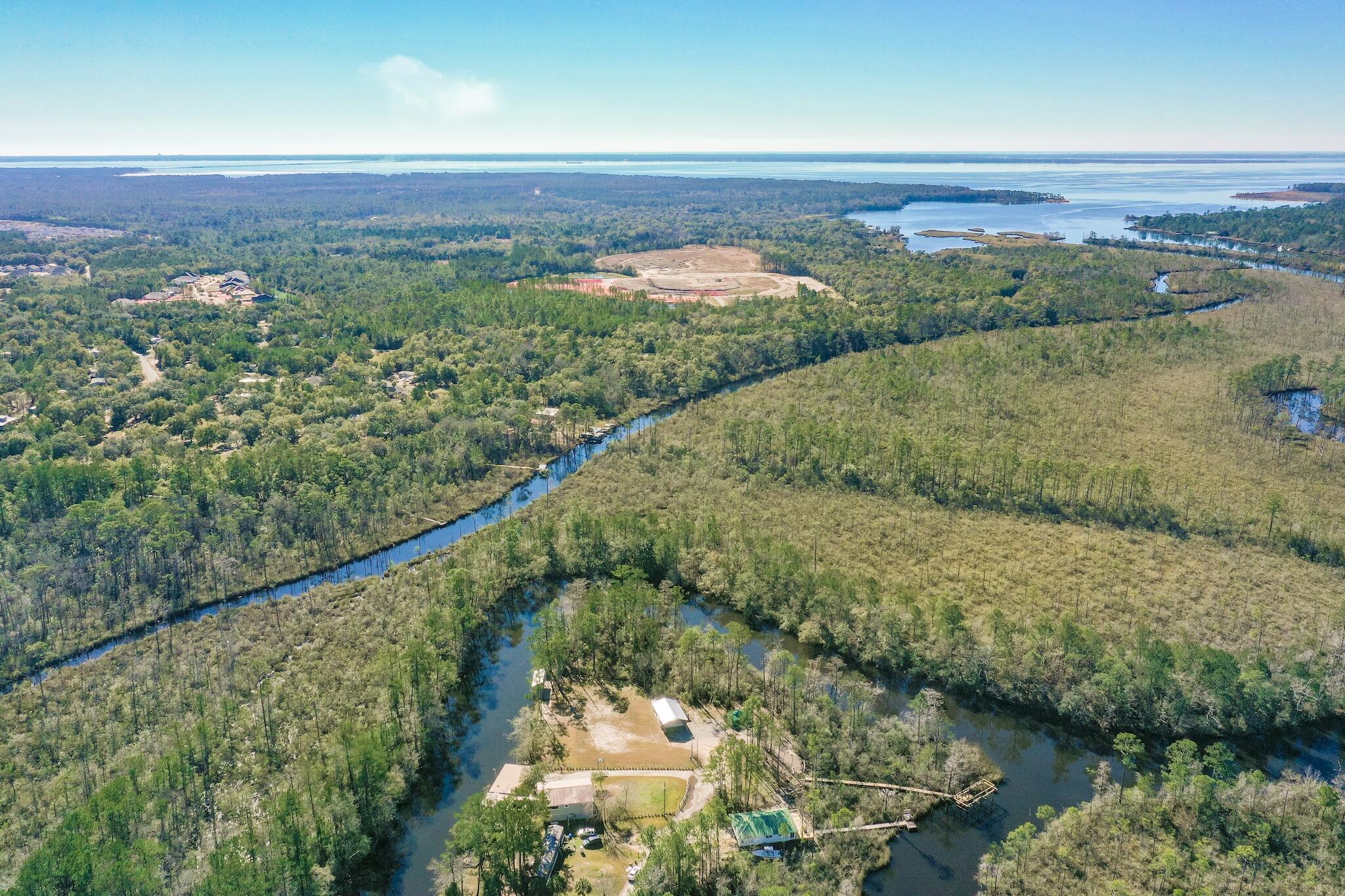 159 Clipper Cove Road Freeport, FL 32439 - Photo 1 of 7 a view of a lake with a mountain in the background