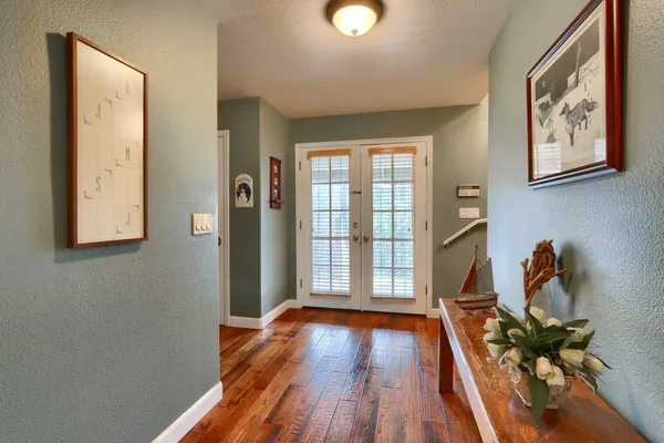 a view of a livingroom with furniture and hardwood floor