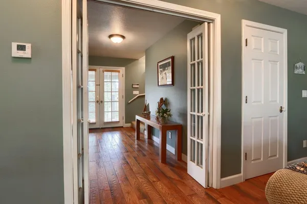 a view of a livingroom with furniture and hardwood floor