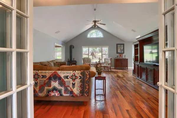 a living room with furniture and a wooden floor