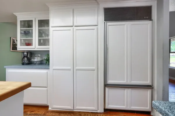 a kitchen with a refrigerator and cabinets