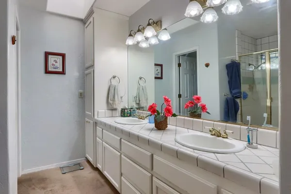 a bathroom with a double vanity sink and a mirror