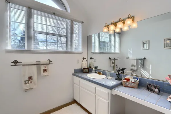 a kitchen with a sink window and cabinets