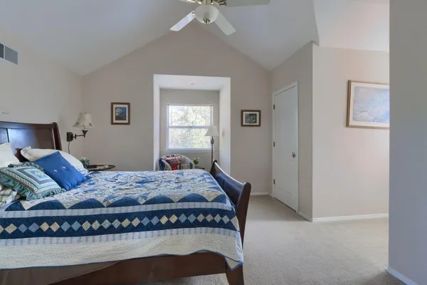 a bedroom with a bed and window