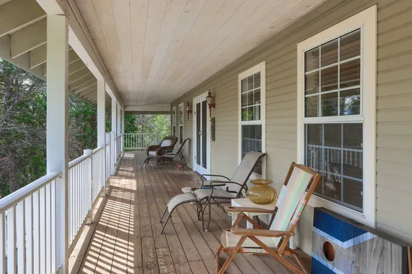 a view of a patio with table and chairs and wooden floor