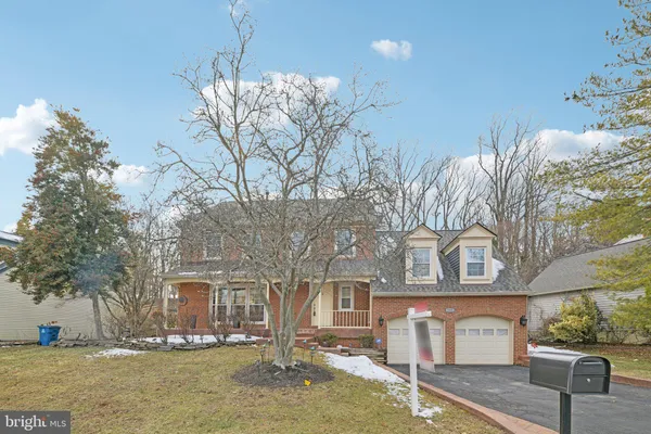 a front view of a building with large trees