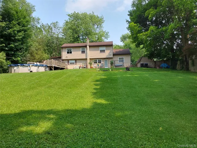 a view of a house with a backyard