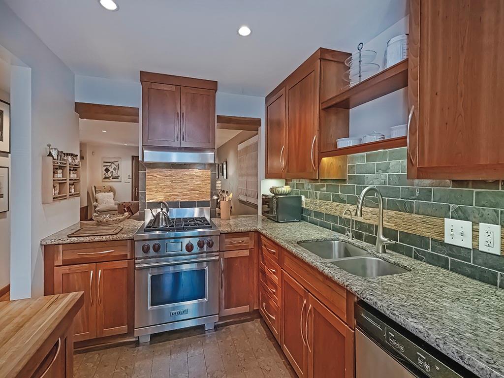 718 Filbert Street Pittsburgh, PA 15232 - Photo 10 of 28 The kitchen features SS appliances, granite countertops, and custom cabinetry, thoughtfully designed to maximize both space and functionality.