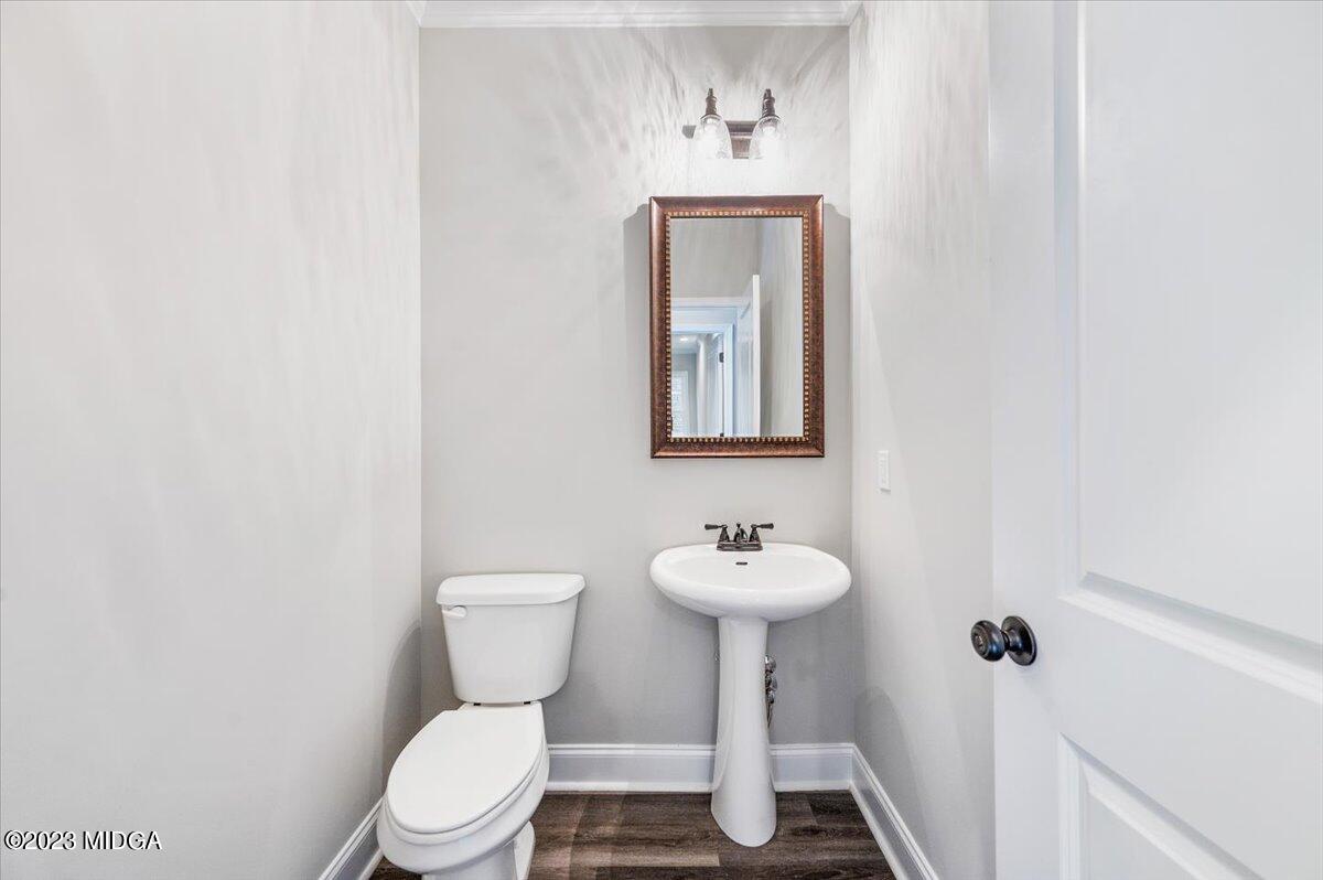 255 High Ridge Court Macon, GA 31220 - Photo 13 of 28 a bathroom with a toilet sink and mirror
