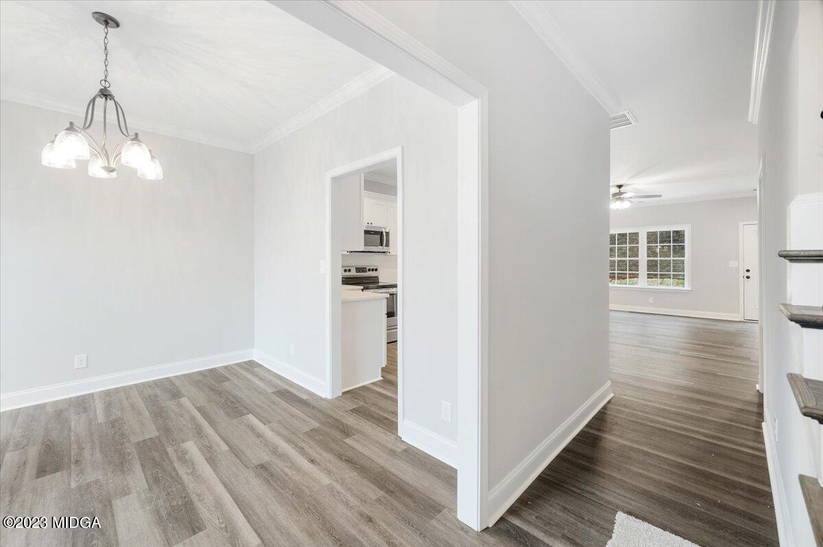 255 High Ridge Court Macon, GA 31220 - Photo 2 of 28 a view of a hallway with wooden floor and a chandelier