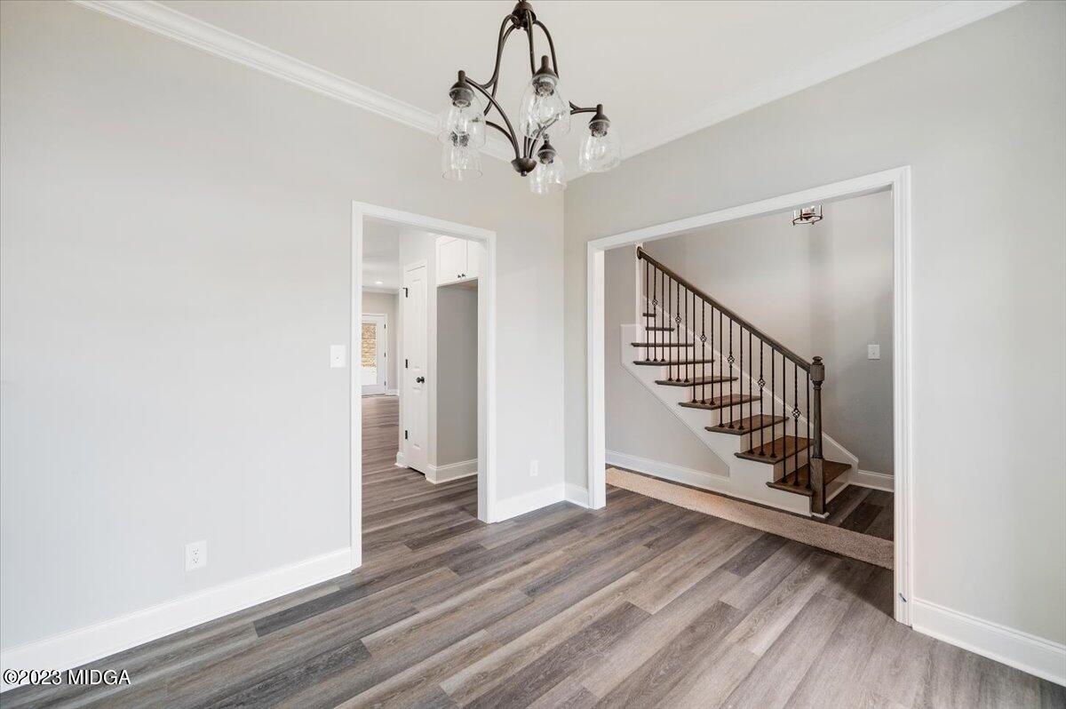 255 High Ridge Court Macon, GA 31220 - Photo 4 of 28 a view of a hallway with wooden floor and staircase