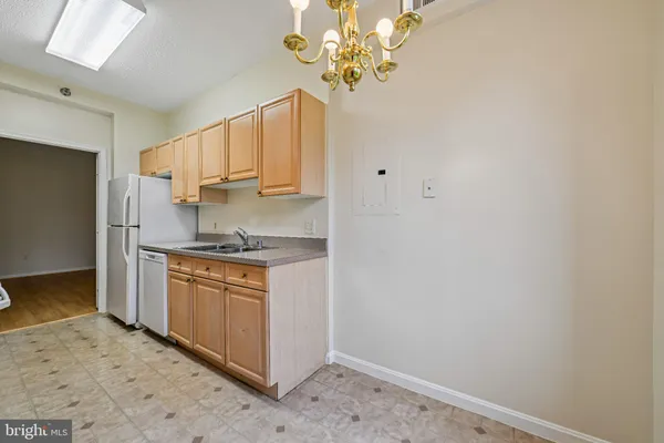 a kitchen with granite countertop white cabinets and stainless steel appliances