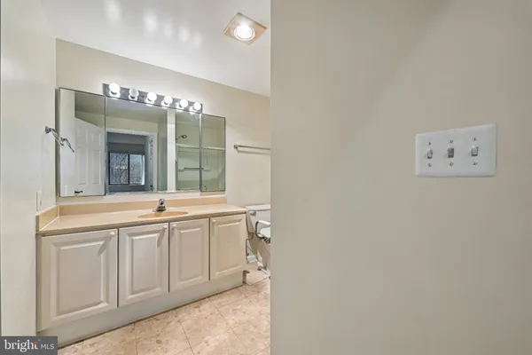 a spacious bathroom with a double vanity sink and a mirror