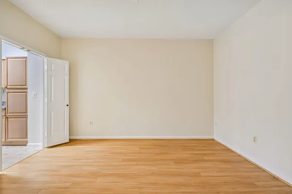 a view of an empty room with wooden floor