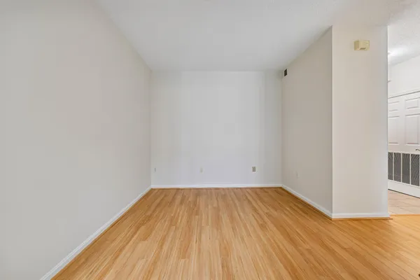 a view of a room with wooden floor