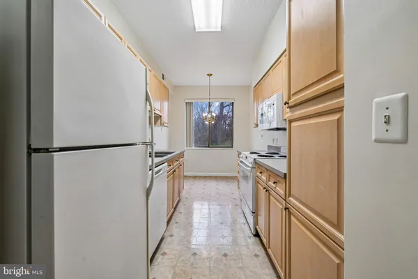 a kitchen with stainless steel appliances granite countertop a refrigerator and a stove