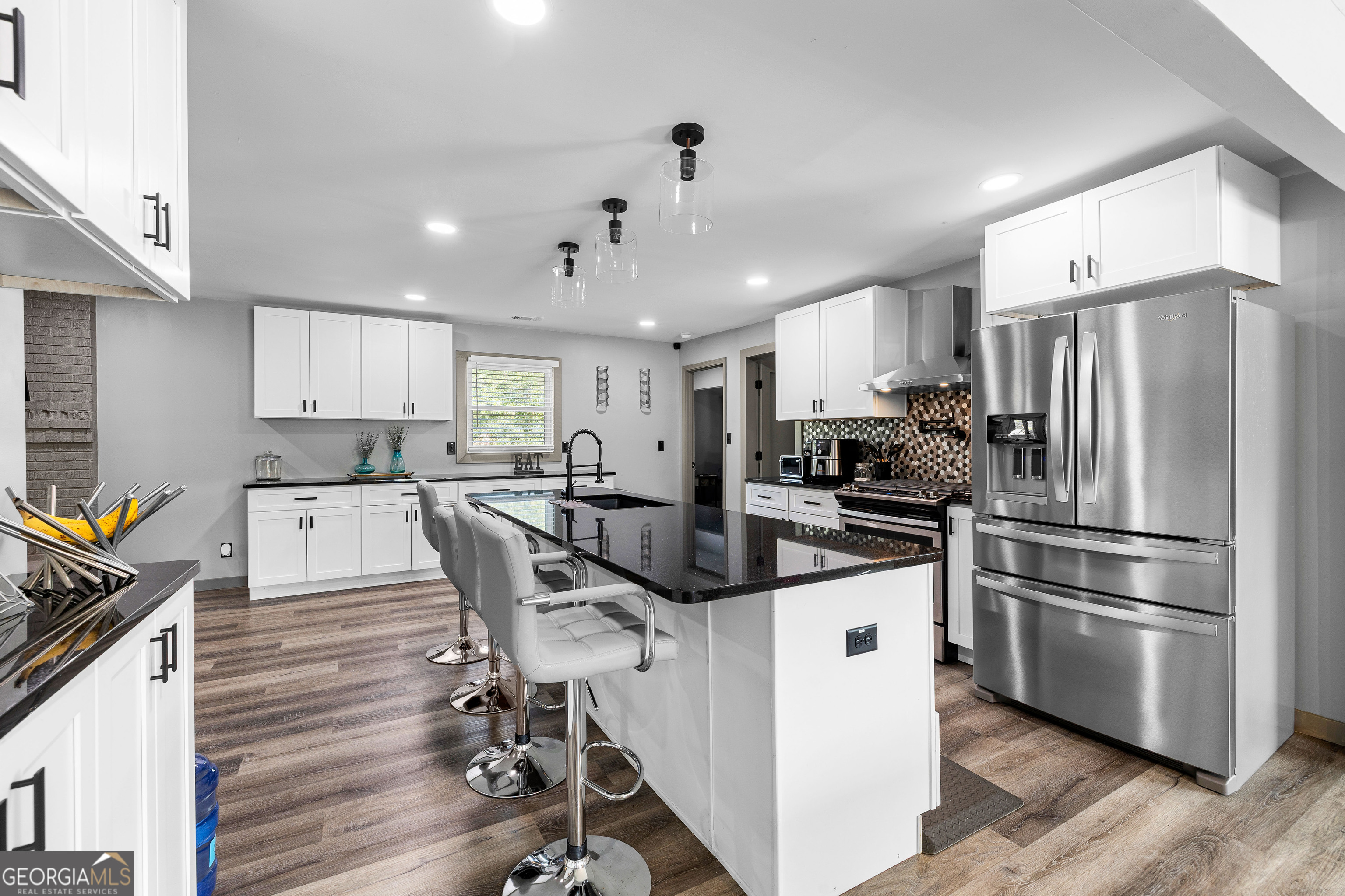 105 Ransby Drive Hogansville, GA 30230 - Photo 11 of 52 a kitchen with kitchen island a stove a refrigerator and a stove with wooden floor
