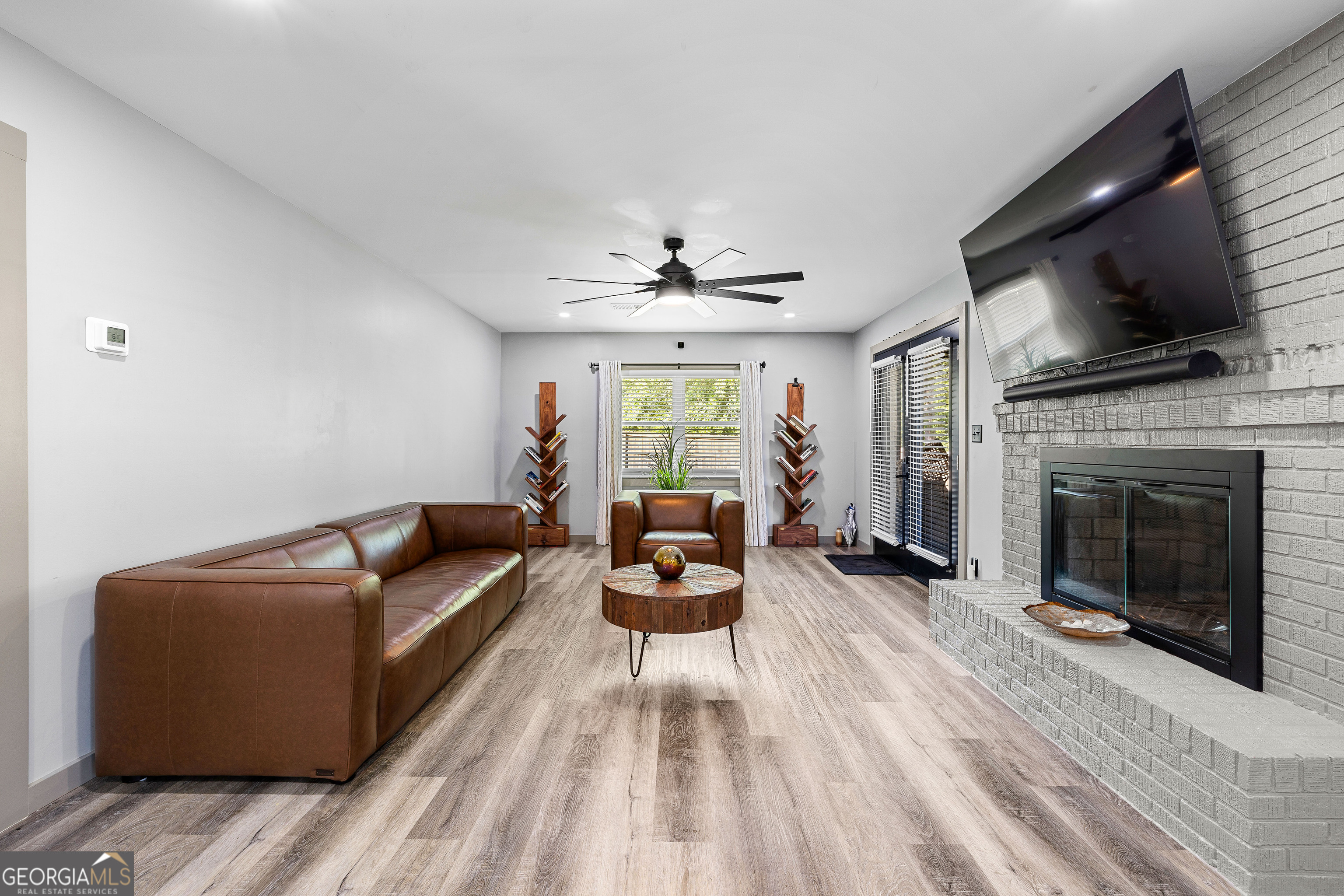 105 Ransby Drive Hogansville, GA 30230 - Photo 13 of 52 a living room with furniture a flat screen tv and a fireplace