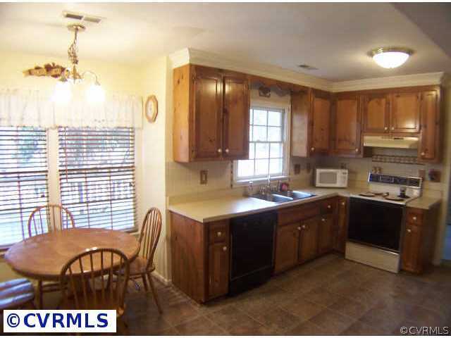 5802 Ridge Point Road Midlothian, VA 23112 - Photo 3 of 10 a kitchen with a stove a sink and a refrigerator