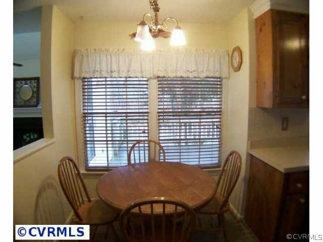 5802 Ridge Point Road Midlothian, VA 23112 - Photo 4 of 10 a view of a dining room with furniture and a chandelier