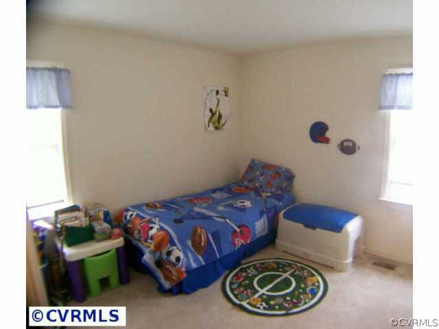 5802 Ridge Point Road Midlothian, VA 23112 - Photo 9 of 10 a bedroom with a bed and a painting on the wall
