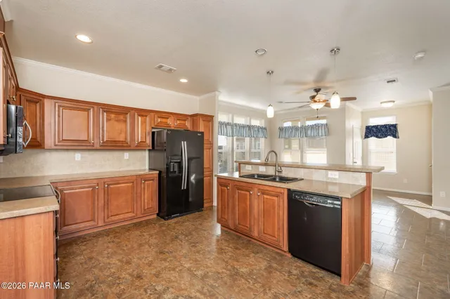 a large kitchen with stainless steel appliances granite countertop a sink and cabinets