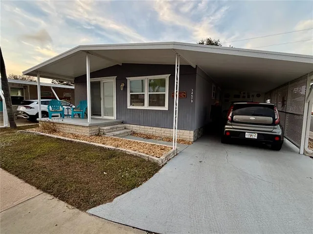 a view of a car park in front of house