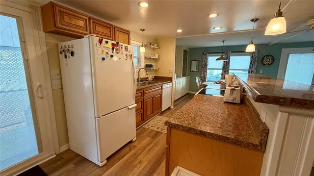 a kitchen with stainless steel appliances granite countertop refrigerator sink and stove