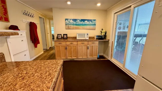 a view of a refrigerator in kitchen and utility room