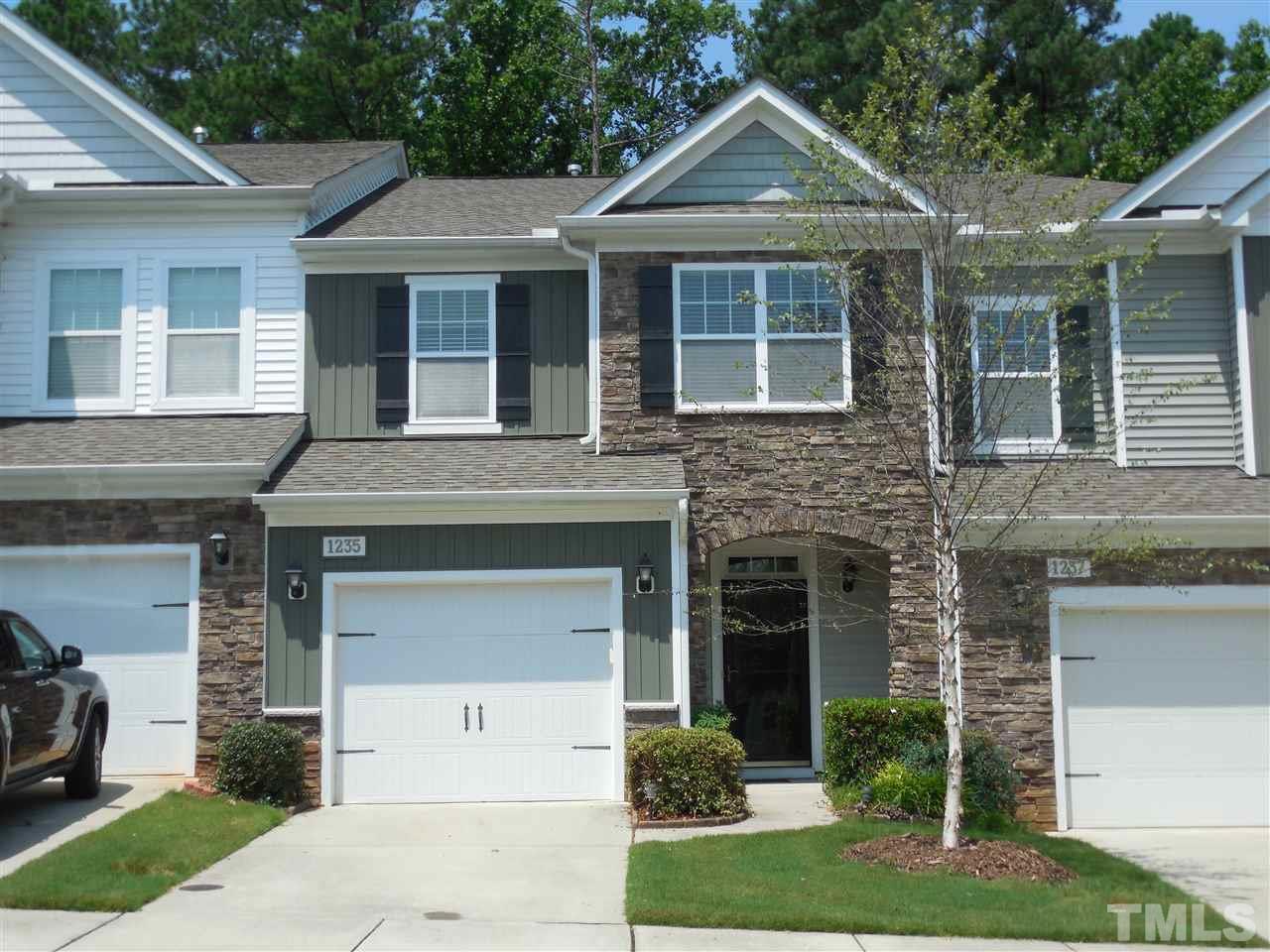1235 Silver Beach Way Raleigh, NC 27606 - Photo 1 of 30 a front view of a house with a garden and garage