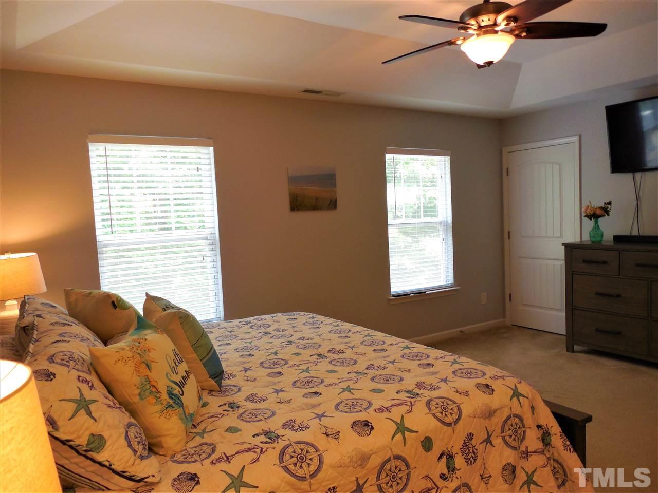 1235 Silver Beach Way Raleigh, NC 27606 - Photo 10 of 30 a bedroom with a bed and a television
