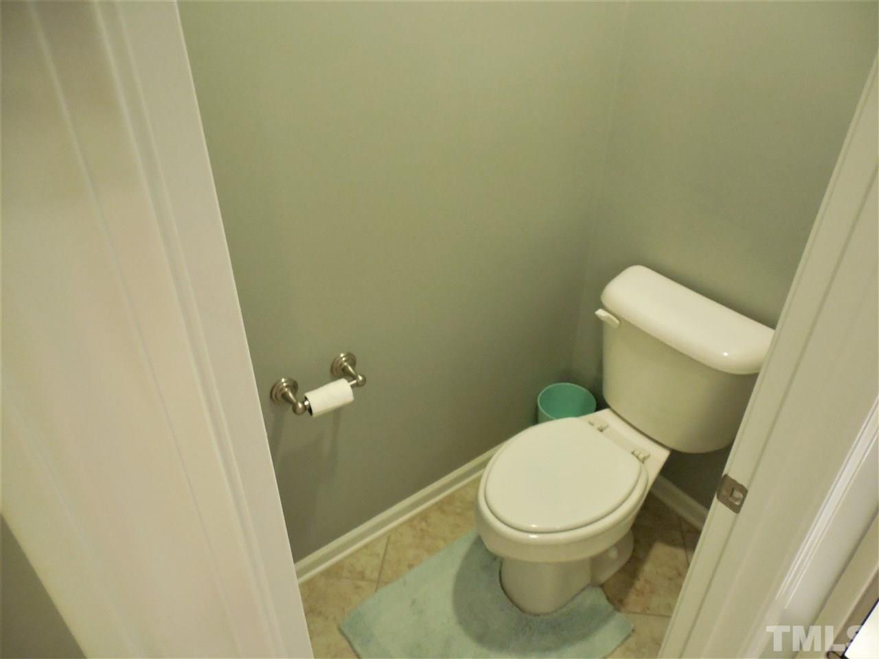1235 Silver Beach Way Raleigh, NC 27606 - Photo 14 of 30 a white toilet sitting next to a shower