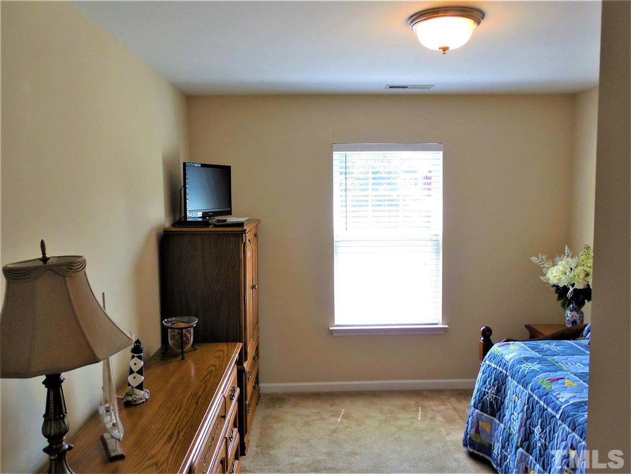 1235 Silver Beach Way Raleigh, NC 27606 - Photo 15 of 30 a bedroom with a bed and a flat screen tv