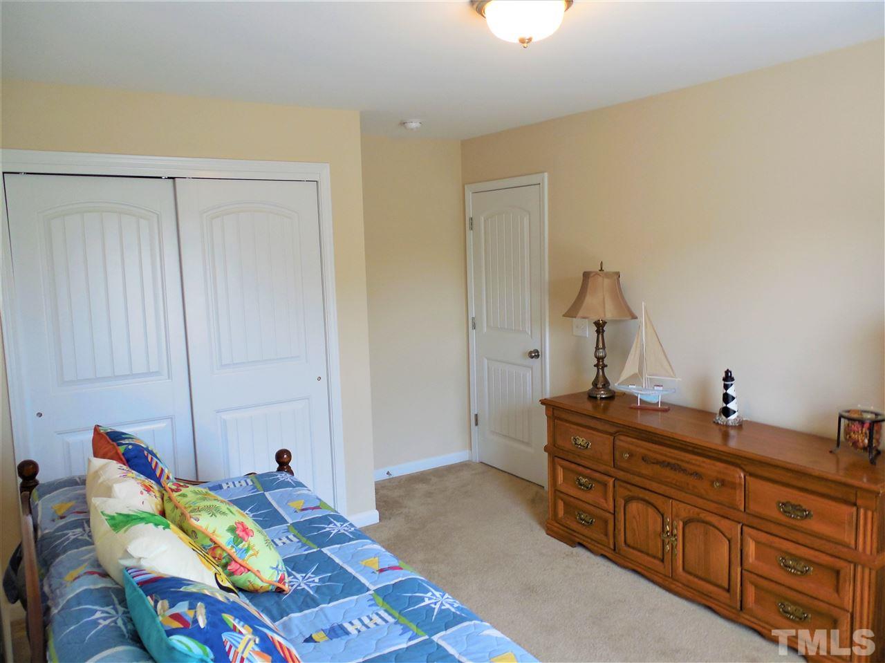 1235 Silver Beach Way Raleigh, NC 27606 - Photo 16 of 30 a bed room with a bed and a dresser