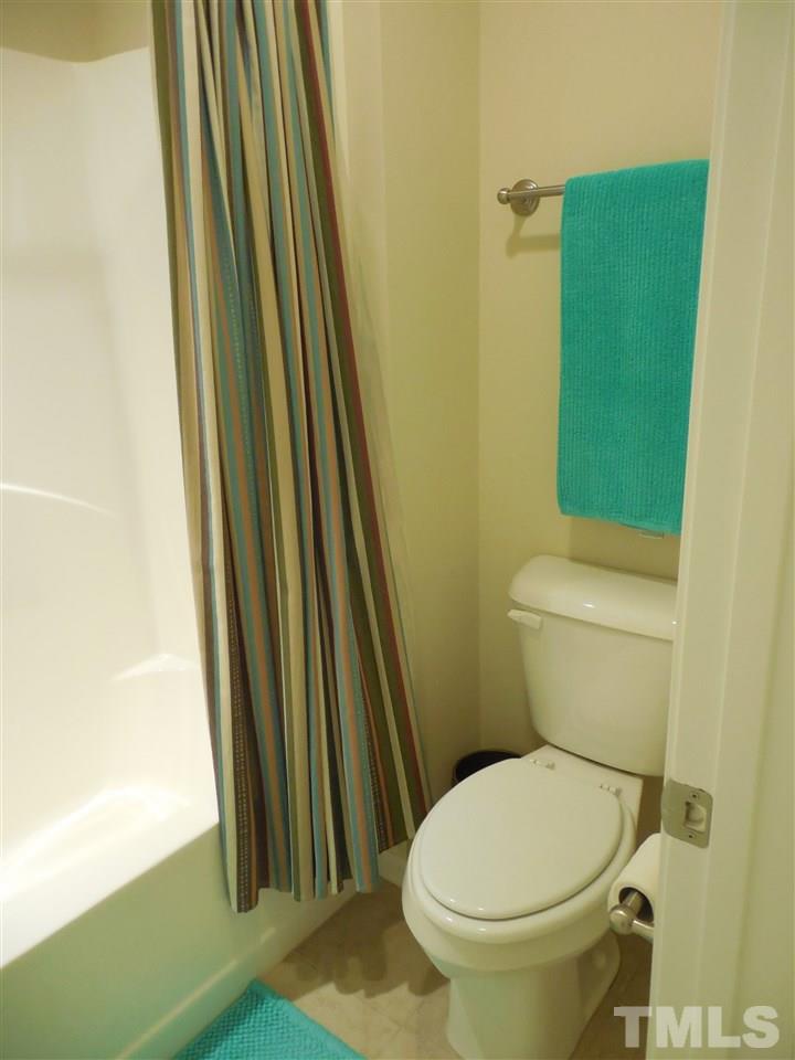1235 Silver Beach Way Raleigh, NC 27606 - Photo 19 of 30 a white toilet sitting next to a sink