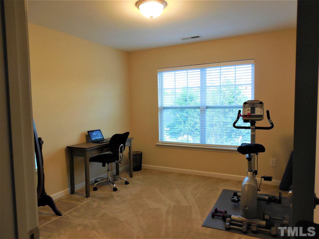 1235 Silver Beach Way Raleigh, NC 27606 - Photo 20 of 30 a room with gym equipment and windows