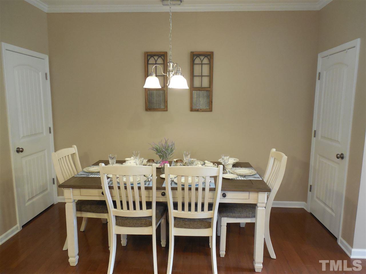 1235 Silver Beach Way Raleigh, NC 27606 - Photo 5 of 30 a view of a dining room with furniture and wooden floor