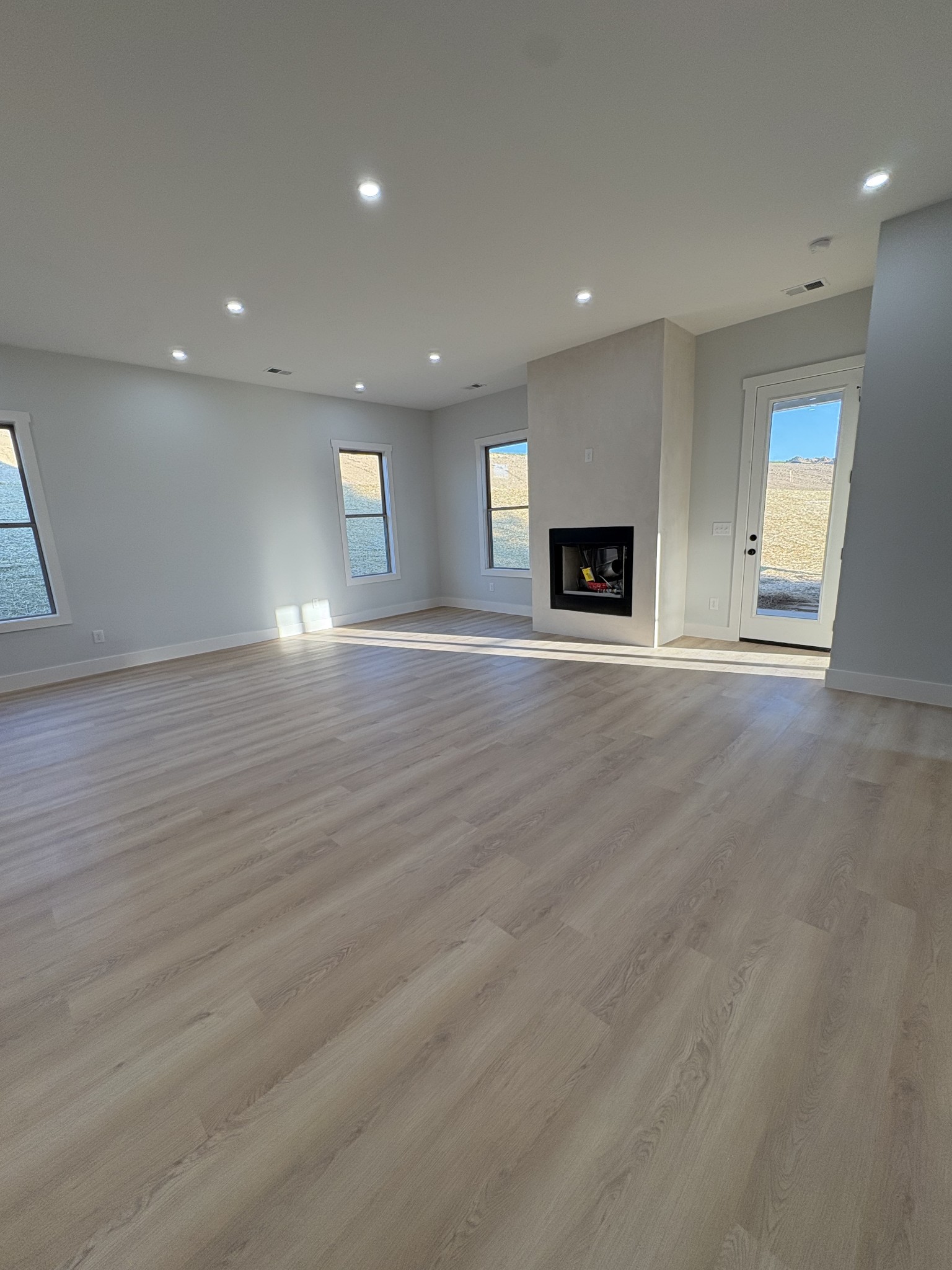 2953 Wixtown Road Westmoreland, TN 37186 - Photo 11 of 35 an empty room with wooden floor and fireplace