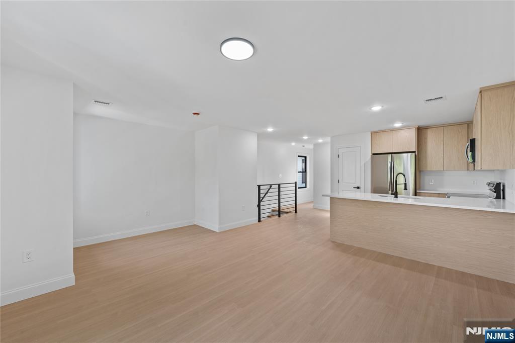 7 Montclair Avenue Paterson, NJ 07503 - Photo 12 of 26 a view of kitchen with refrigerator sink and wooden floor