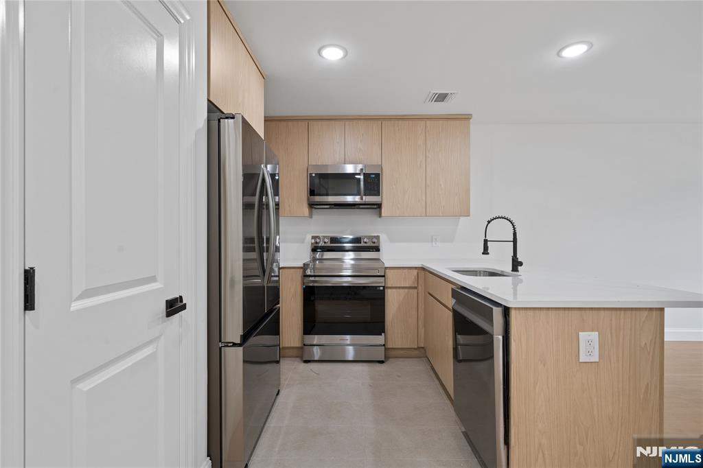 7 Montclair Avenue Paterson, NJ 07503 - Photo 16 of 26 a kitchen with stainless steel appliances granite countertop a refrigerator and a stove top oven