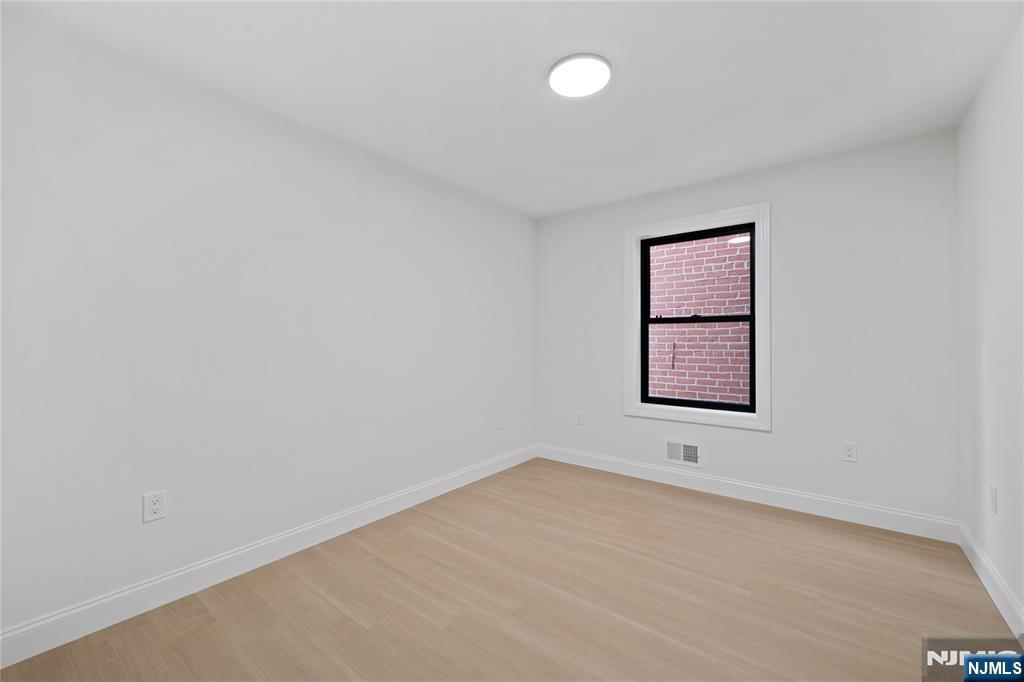 7 Montclair Avenue Paterson, NJ 07503 - Photo 17 of 26 an empty room with a window