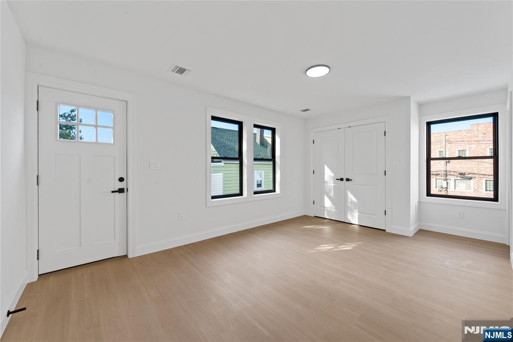 7 Montclair Avenue Paterson, NJ 07503 - Photo 21 of 26 a view of an empty room with a window and wooden floor