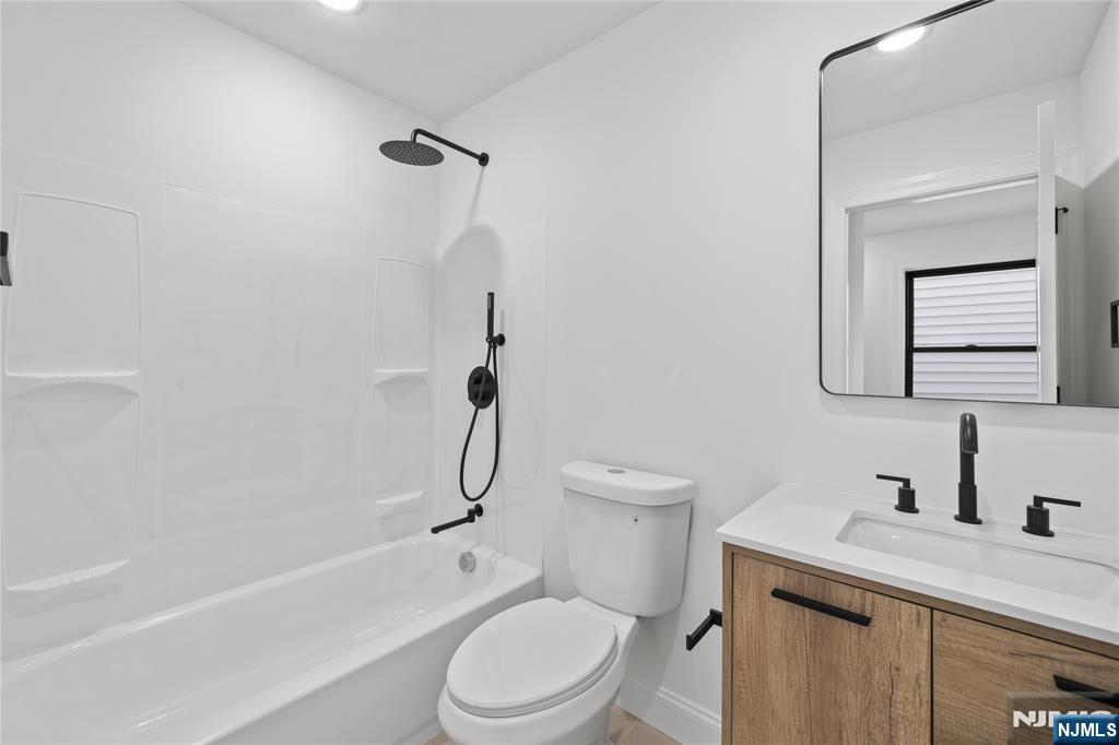 7 Montclair Avenue Paterson, NJ 07503 - Photo 7 of 26 a white toilet sitting next to a bath tub