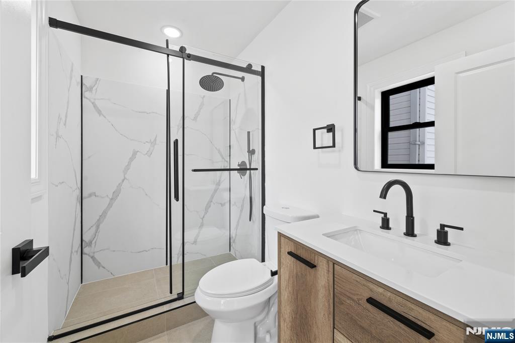 7 Montclair Avenue Paterson, NJ 07503 - Photo 10 of 26 a bathroom with a sink toilet and shower