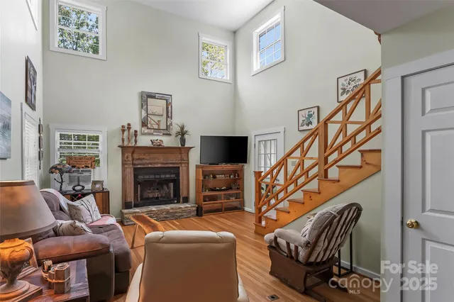 a living room with furniture a fireplace and a flat screen tv