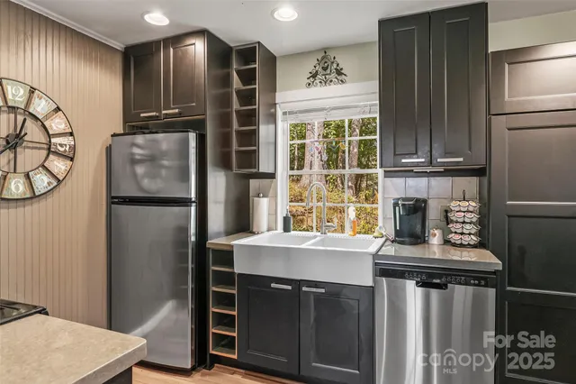 a kitchen with stainless steel appliances granite countertop a refrigerator and a stove