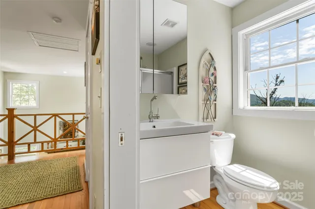 a white toilet sitting next to a bathroom sink