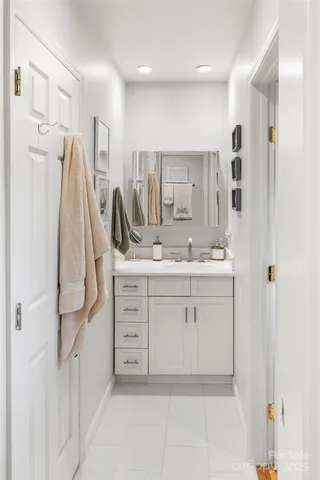 a bathroom with a sink shower and a mirror