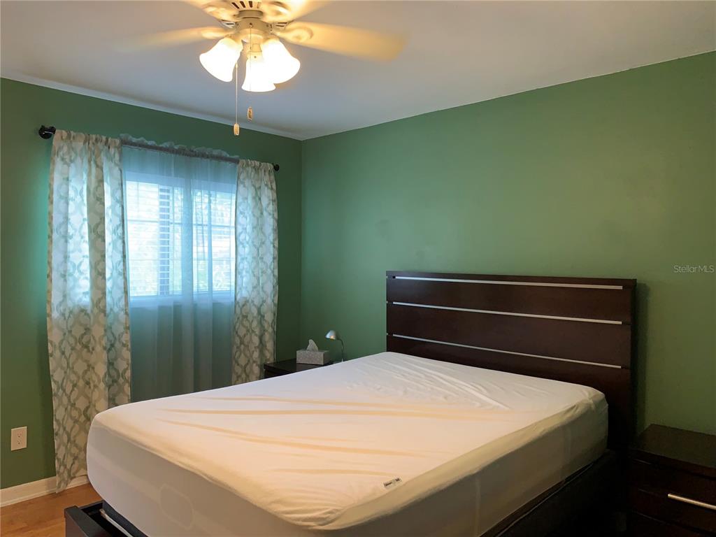 5754 Southwest 8th Place Gainesville, FL 32607 - Photo 15 of 29 a bedroom with a bed and a chandelier