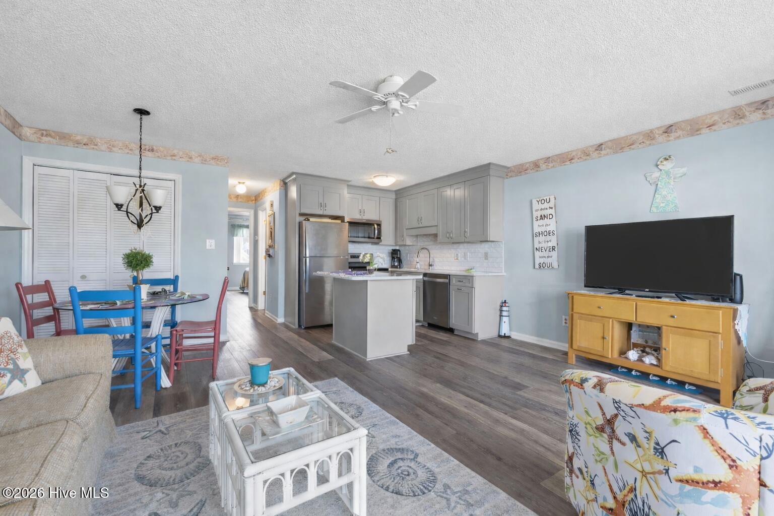 9201 Coast Guard Road, Unit I207 Emerald Isle, NC 28594 - Photo 9 of 26 Updated kitchen showcasing quartz-style countertops, stainless steel appliances, and full-height cabinetry. Functional layout for living area